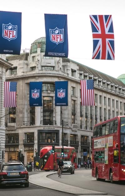 City of London street with NFL and British flag hanging overhead