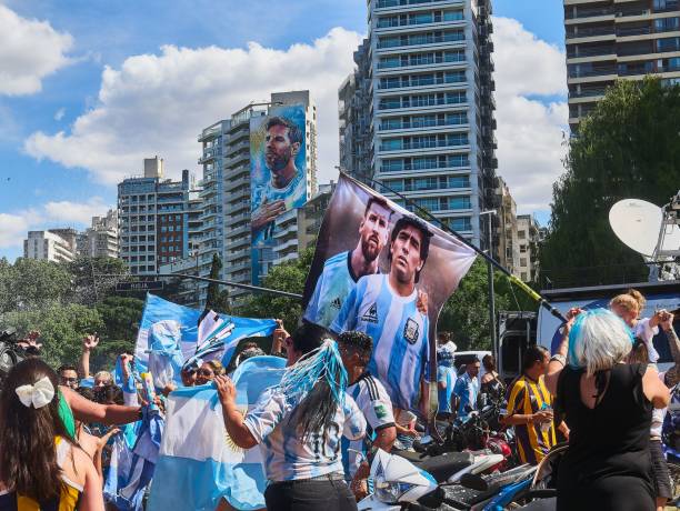 Argentina football fans waving flags in street  